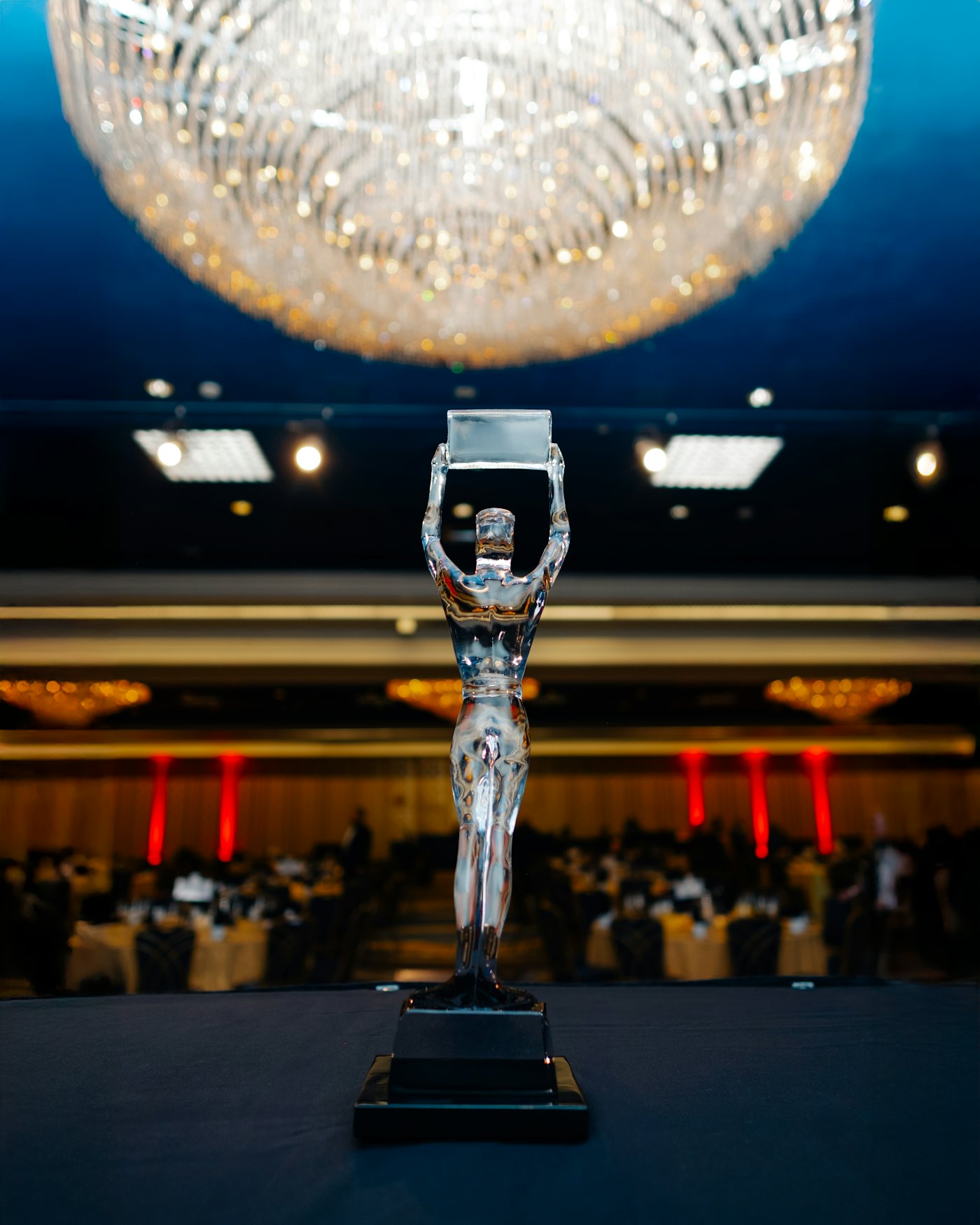 A trophy statuette in a banquet hall before an award ceremony