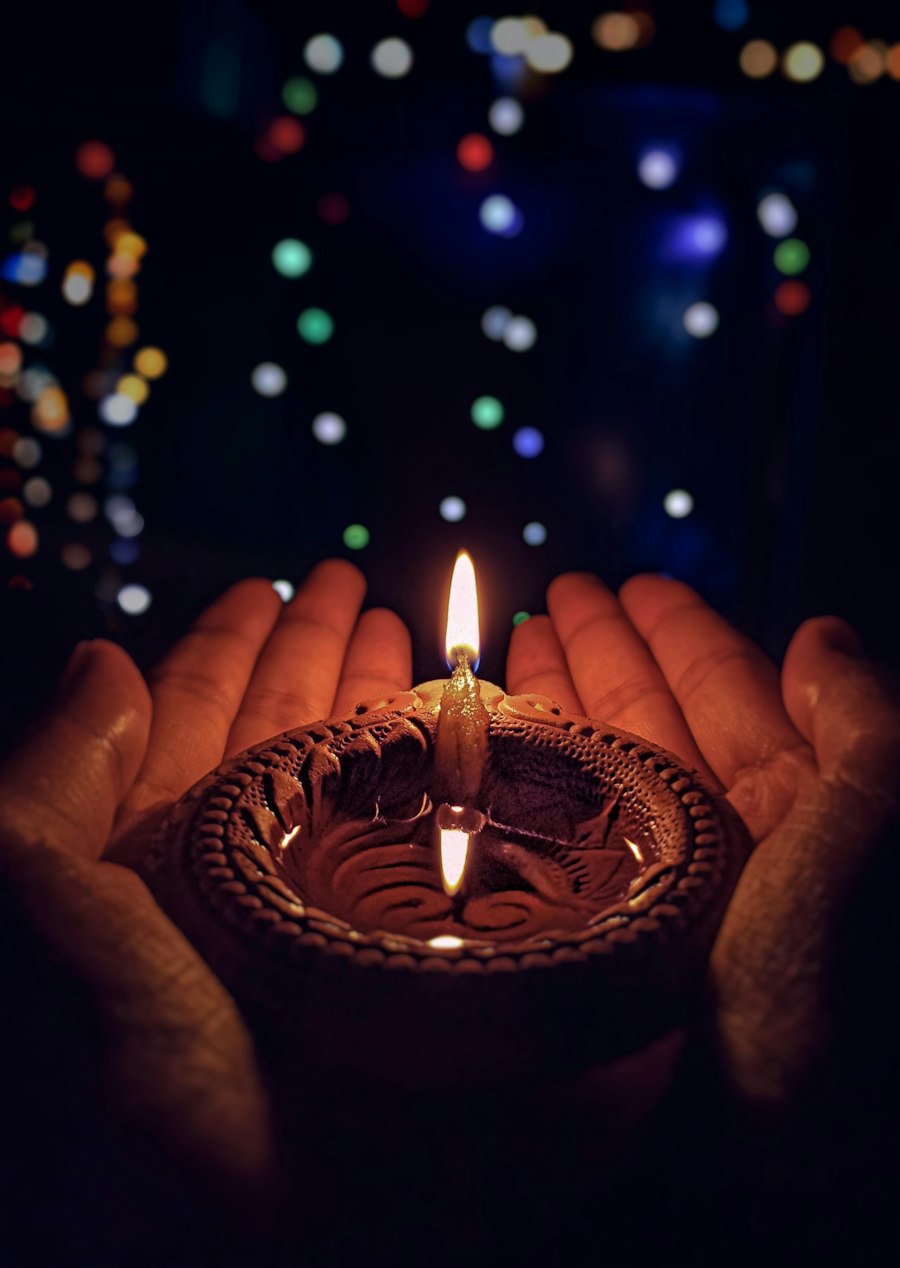 A diya held in both hands